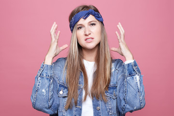 Portrait of young attractive woman wearing street style clothes, has frustrated face. Outraged...