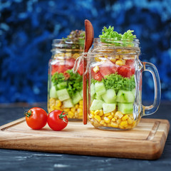 Vegetable salad in a glass jar and a spoon. Square. Healthy food, Diet,