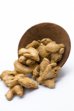 Close up of Dried ginger or Sonth isolated on white in a clay bowl.