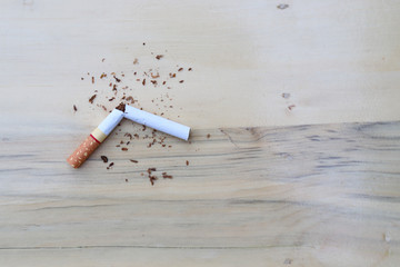Cutting cigarette on the table, symbol of stop smoking.