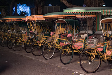 Fototapeta na wymiar Empty typical chinese rickshaws on night street of Macau