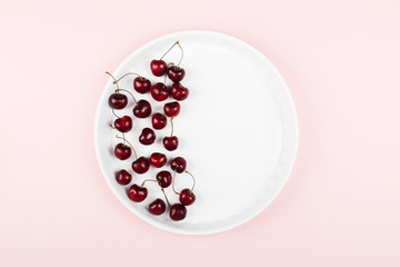Ripe cherry on a pink background. Top view, copy space. Food background