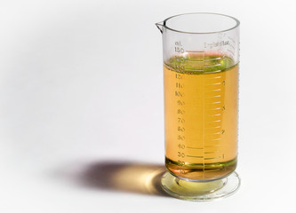 Beaker or flask with yellow liquid isolated on white background