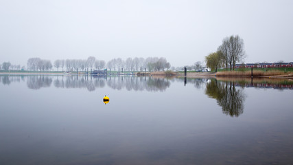 Obraz premium Dutch river landscape. View from the Island of Maurik in Gelderland, Netehralds