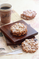 Crumble Cookies powered with icing sugar, on square wooden board