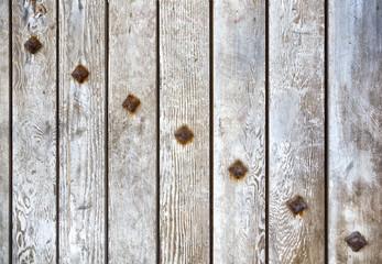 Wooden texture of ancient gate with rusted bolts, empty wood background