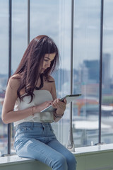 Young working woman in office holding tablet computer, new generations lifestyle concept.