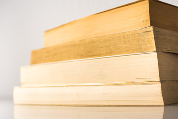 Many stacked books with white background with space