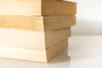 Many stacked books with white background with space