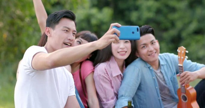 Young people taking selfie in picnic time