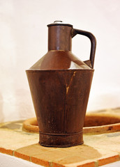 Old pitcher for olive oil in rusty metal sheet, Andalusia, Spain