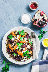 Healthy vegetarian salad, roasted root vegetables, lentils and feta cheese.Top view, space for text.