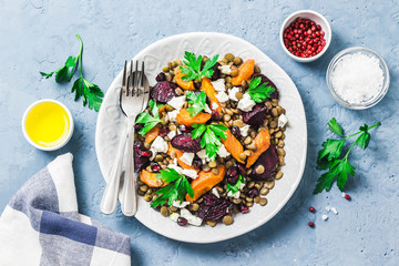 Healthy vegetarian salad, roasted root vegetables, lentils and feta cheese.Top view, space for text.