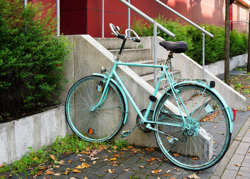 painted bicycle locked to railing