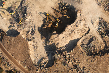 Dozers and trucks at building site.