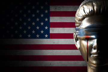 Bloody tear of Lady Justice on U.S.A. flag background (Concept of injustice)