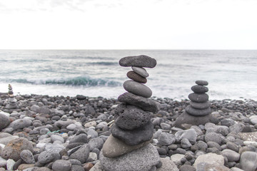Puerto de la Cruz. Stone piles ( Cairns) on Playa Jardin, Peurto de la Cruz, Tenerife, Canary Islands, Spain. Selfmade rock-monument at the beach of Puerto de la Cruz Tenerife.
