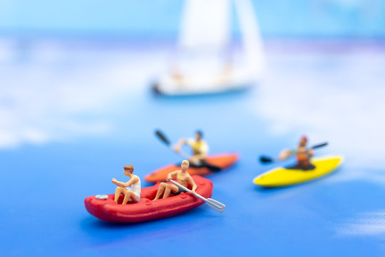 Miniature people, Rowing boat in the ocean. Image use for sports concept.