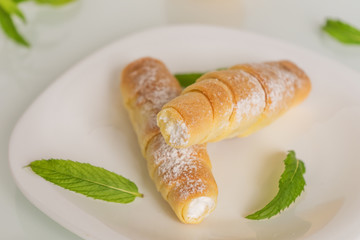 Tubules with cream, mint and apricots on a white background