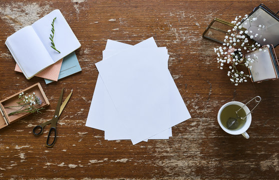 blank sheets of paper creative chaos on desk inspiration