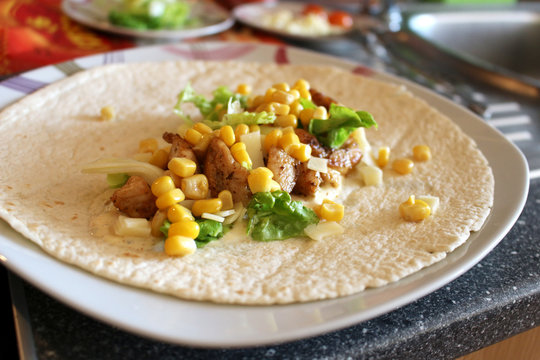Healthy tortilla with meat, salad, cheese and corn