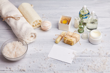 Homemade soap, dry lavender flowers and essential oil. Top view. Natural cosmetic oil, sea salt and handmade soap, towel on light background. Aromatherapy, spa and wellness concept