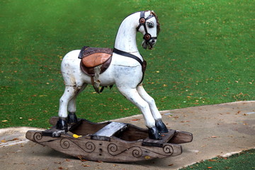 Old wooden horse white in the garden, Vintage retro toy wooden rocking horse