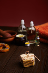 Bar of handmade soap on dark wood background. Natural cosmetic oil, cream, and natural handmade wax with lavender on dark background. Healthy skin care. Aromatherapy, spa and wellness concept