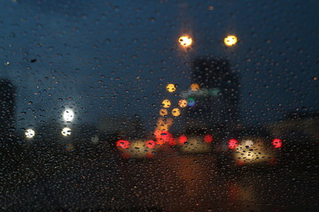 Nightlife background bokeh and raindrop on glass blurred bokeh lighting colorful condensation