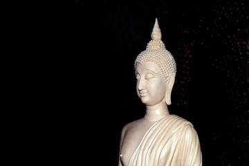 White Buddha statue on black background, The Buddha is made of ivory carved white, Ivory carved