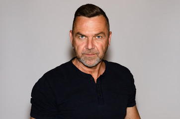 Portrait of mature man against white background