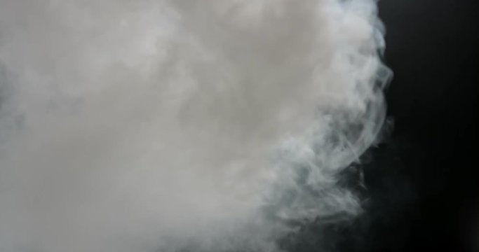 Dense cloud of thick cotton smoke filling frame with turbulence on the side