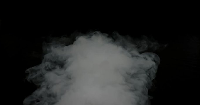 Heavy plume of thick smoke center frame against black