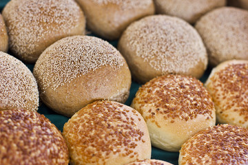 Fresh buns from yeast dough with sesame and poppy seeds