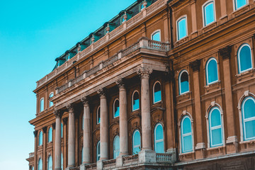 brown facade of royal palace at budapest with some pillars