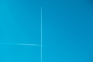 contrail lines in the blue sky