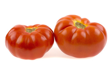 two tomatoes on a white background