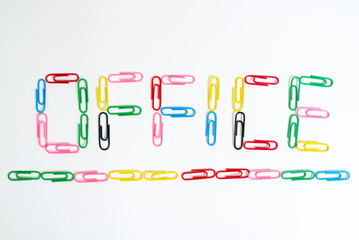 Word OFFICE from colored paper clips on white