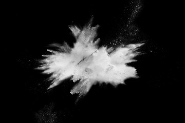 Launched white powder splash on black background.Stopping the movement of white powder on dark...