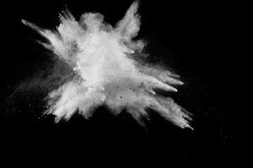 Launched white powder splash on black background.Stopping the movement of white powder on dark...