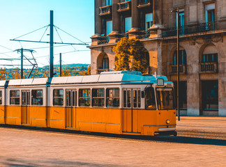 Fototapeta na wymiar orange and white colored tram at budapest