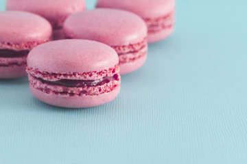 Pink French Macarons on a Blue Background