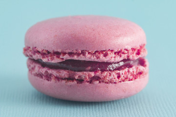 Obraz na płótnie Canvas Pink French Macarons on a Blue Background
