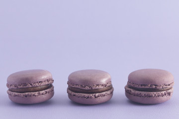 Purple French Macarons on a Purple Background