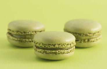 Green French Macarons on a Green Background