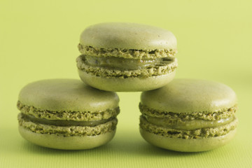 Green French Macarons on a Green Background