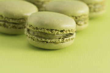 Green French Macarons on a Green Background