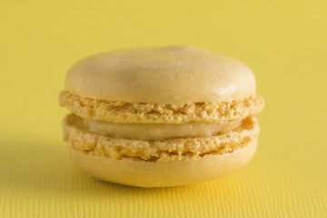 Yellow French Macarons on a Yellow Background