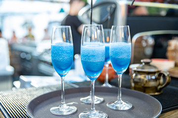 Martini. Alcohol drinks and cocktails on bar. colored light