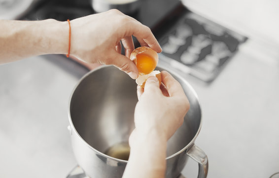 Cook pours egg in metal plate